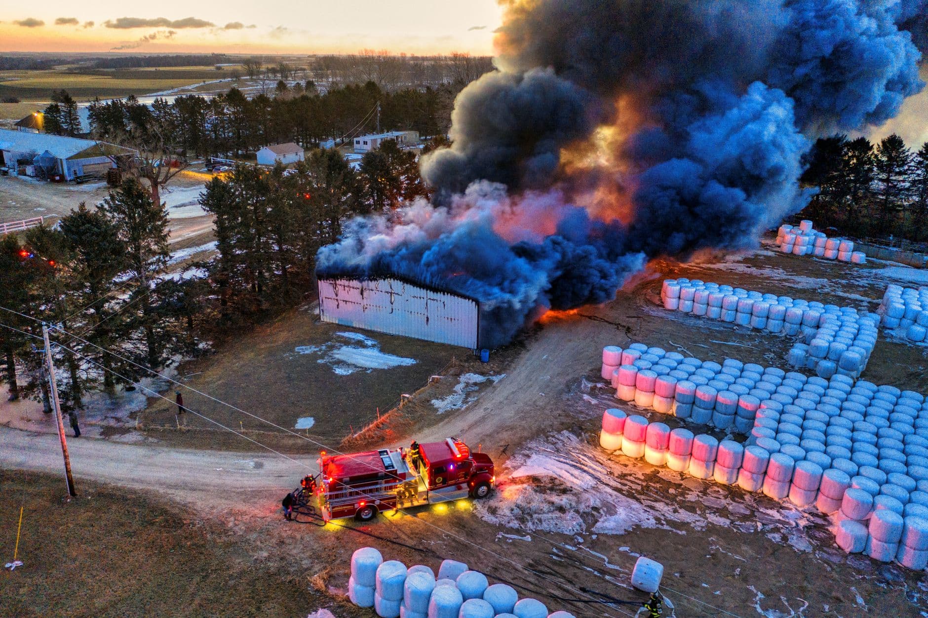 Image illustrating: Firefighters at a burned-out barn in a Flemish village setting (editorial)