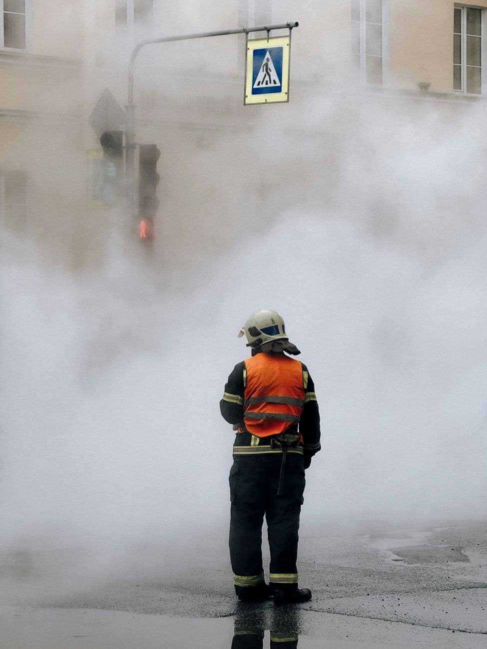 Image illustrating: Brussels firefighters responding to an urban fire with visible smoke (editorial)