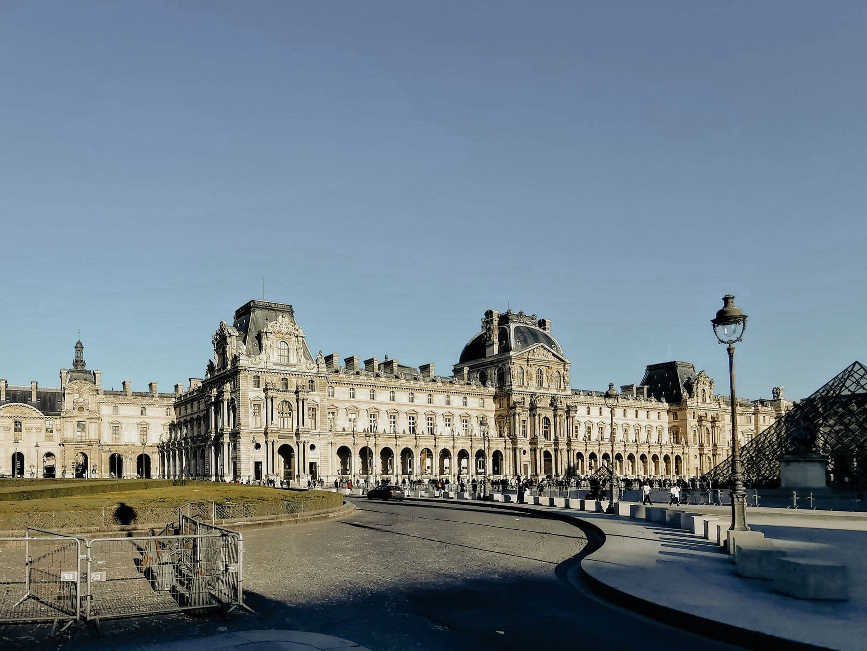 Image illustrating: Exterior of the Louvre Museum in Paris with police or security presence (editorial)