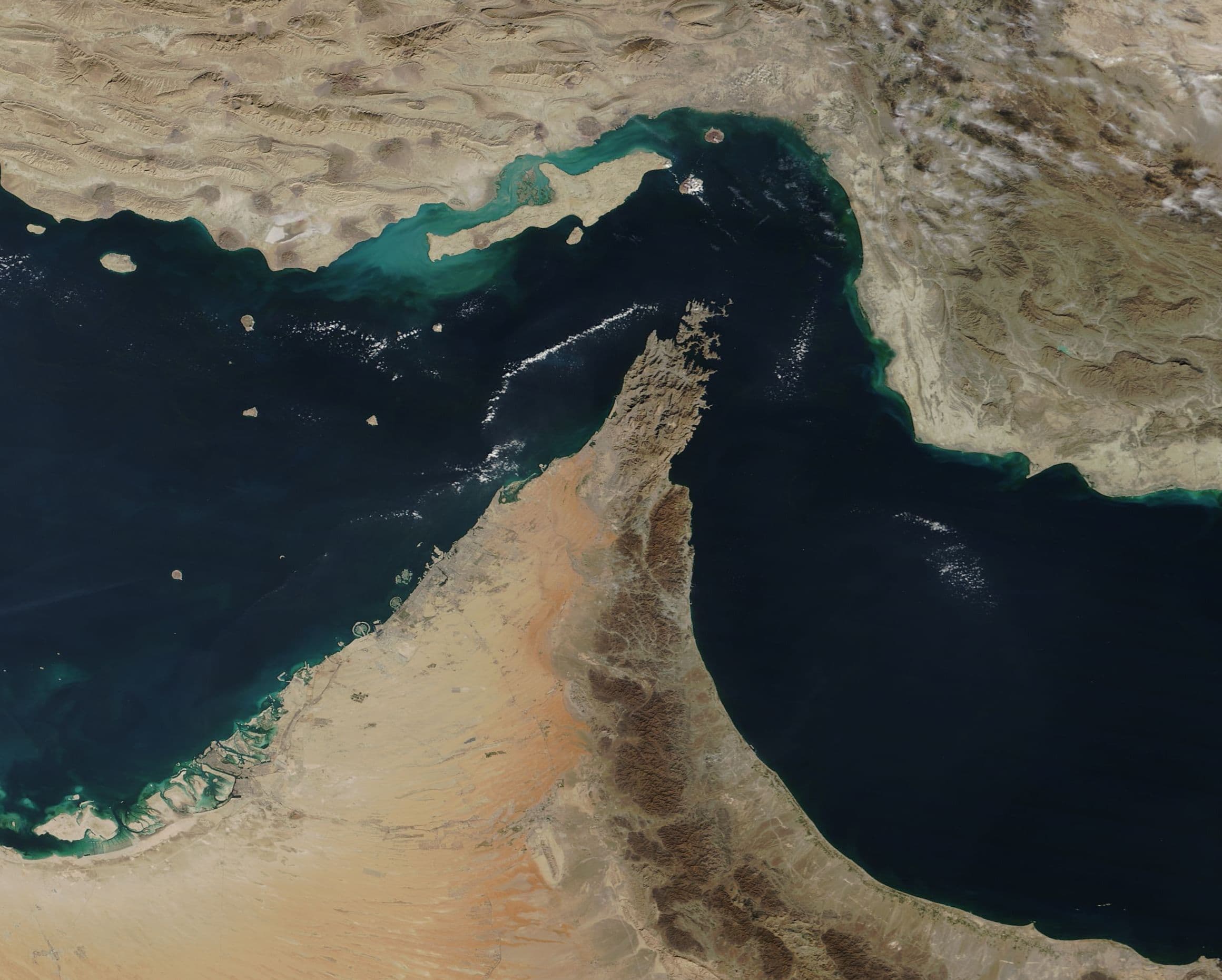 Satellite view of the Strait of Hormuz between Iran and the Musandam Peninsula, connecting the Persian Gulf and Gulf of Oman.