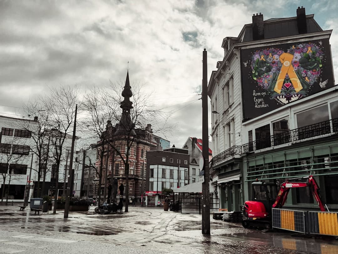 Image illustrating: dark thunderclouds over a Belgian street with rain beginning (editorial)