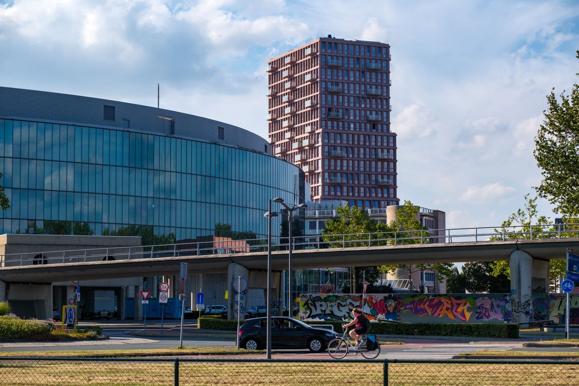 Image illustrating: Cyclists and pedestrians near a Leuven road junction with a modern bridge connec (editorial)