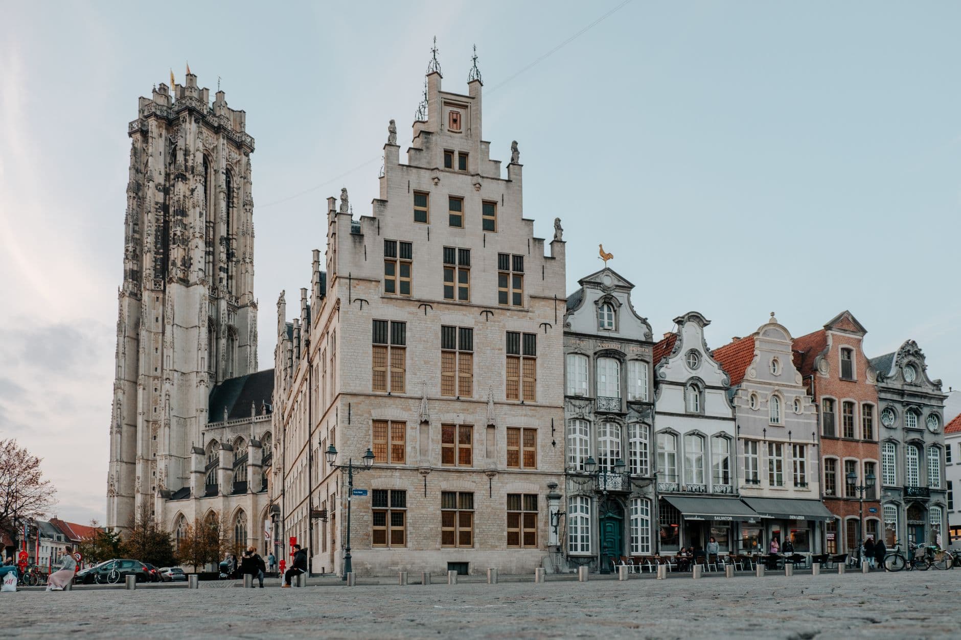 Image illustrating: Residents following a guide near Mechelen’s Grote Markt and Sint-Romboutstoren (editorial)