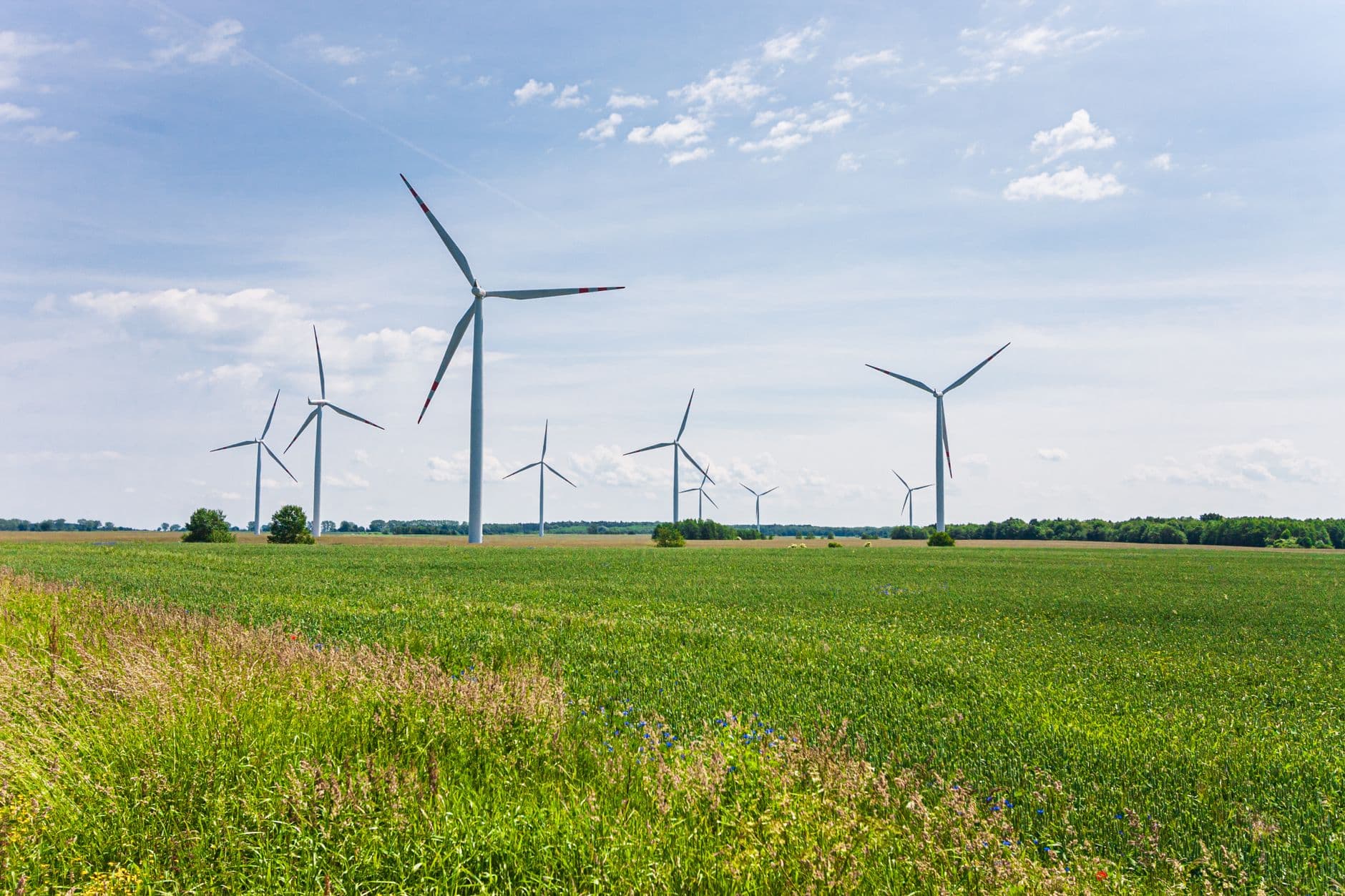Image illustrating: Wind turbines in open countryside near a Walloon town (editorial)