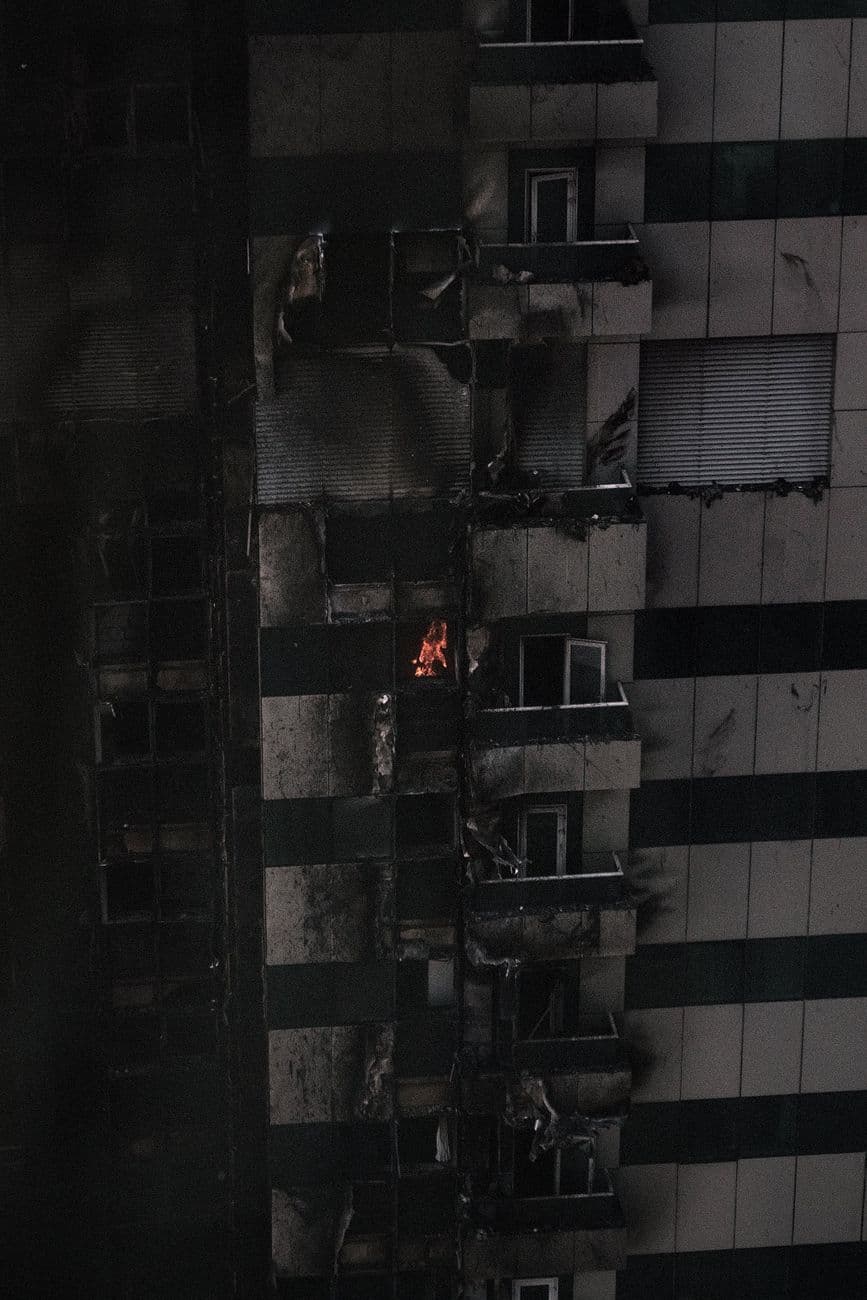 Image illustrating: Firefighters and emergency vehicles outside an apartment building in Molenbeek (editorial)