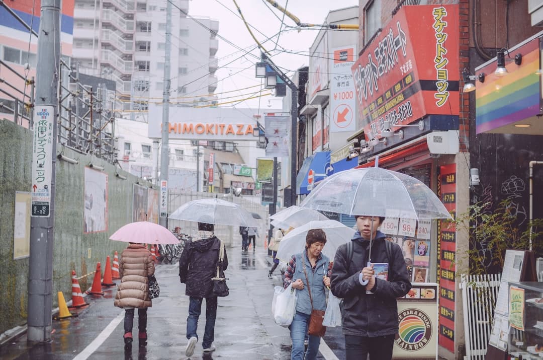Image illustrating: People in Tokyo walking through heavy rain as Tropical Storm Jangmi raises flood (editorial)